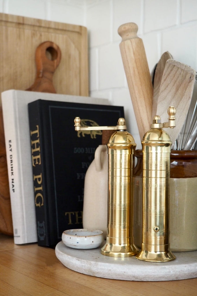 European solid brass salt and pepper mills from Greece displayed in a kitchen